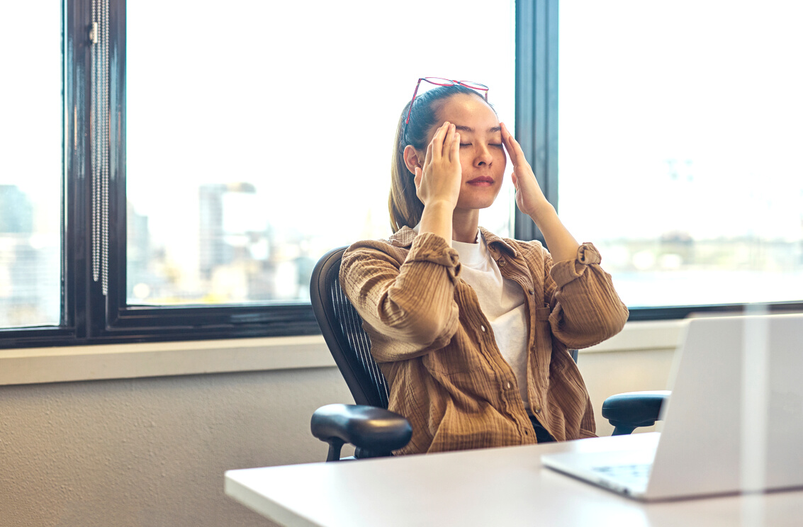 Young office worker struggling with mental health in the workplace